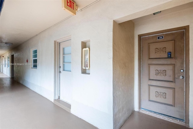 entrance to property with stucco siding