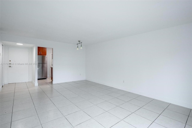 spare room featuring light tile patterned floors