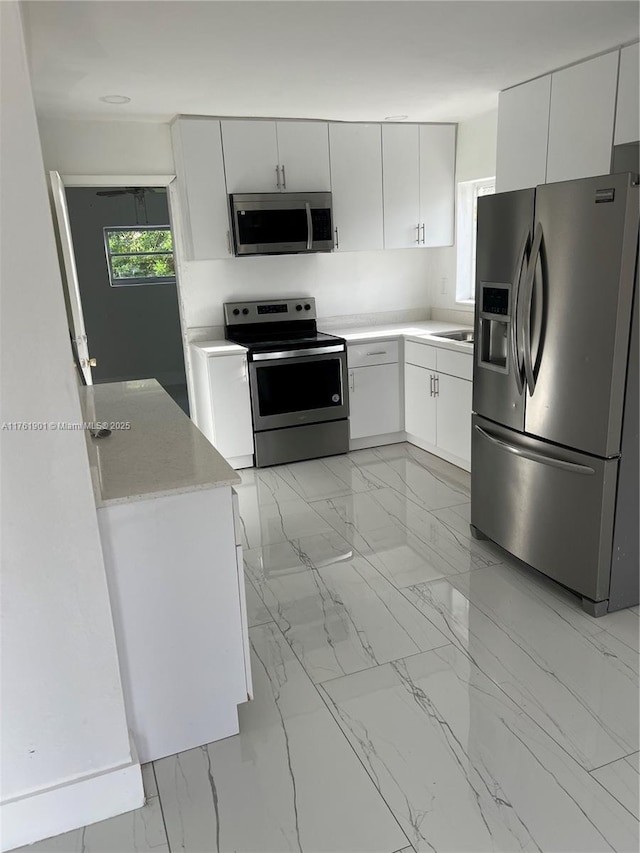 20 NE 215th St, Miami Gardens, FL 33179 - kitchen with a sink, marble finish floor, light countertops, and stainless steel appliances