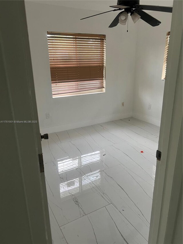 20 NE 215th St, Miami Gardens, FL 33179 - unfurnished room with marble finish floor, baseboards, and a ceiling fan