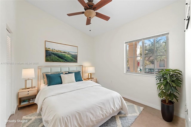 bedroom featuring light tile patterned flooring, baseboards, and ceiling fan