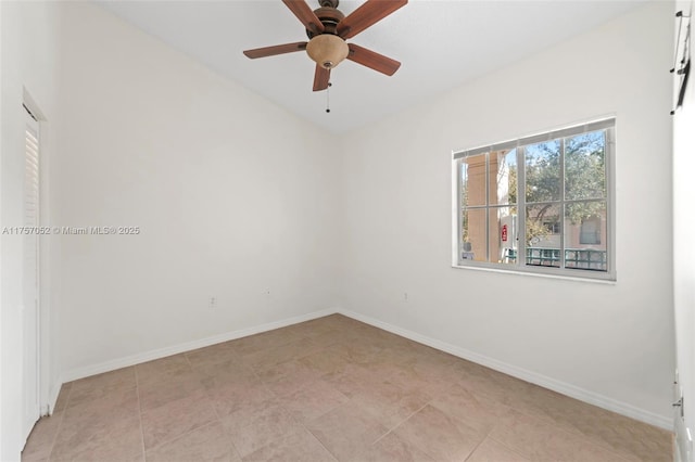 spare room with baseboards and ceiling fan