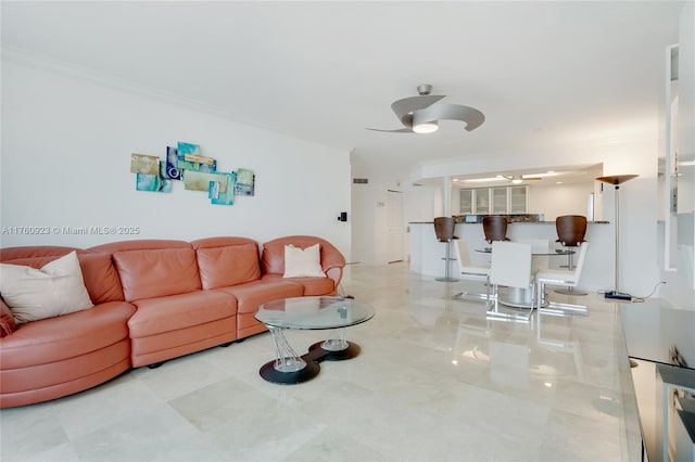 living room featuring crown molding and ceiling fan