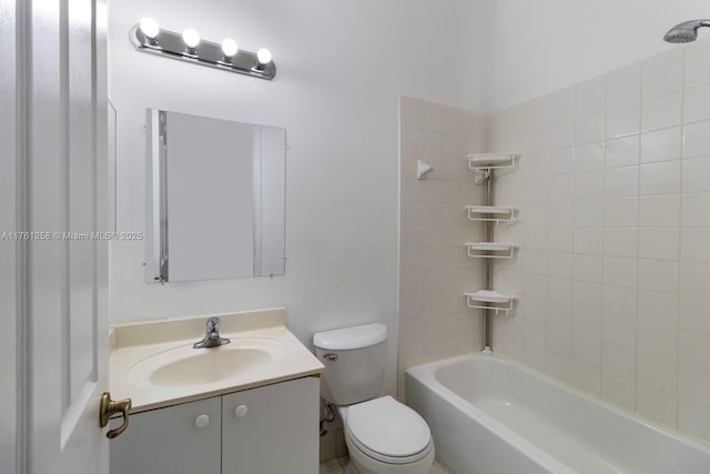 bathroom featuring toilet, vanity, and bathing tub / shower combination