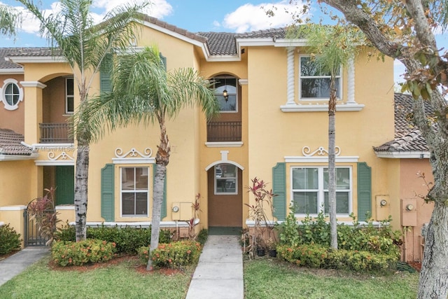 view of front of property featuring a tile roof and stucco siding