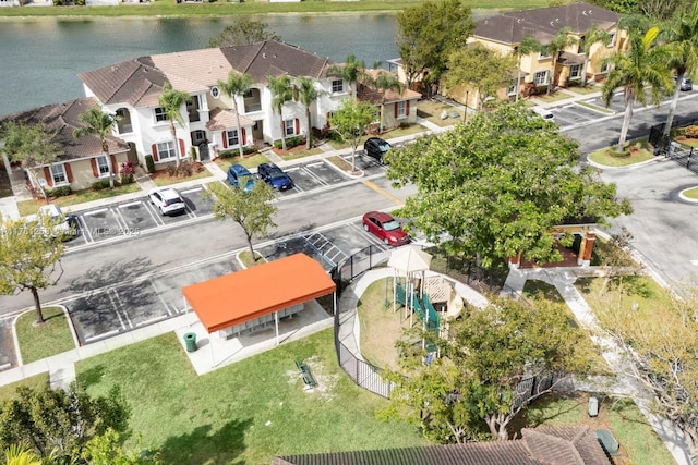 drone / aerial view featuring a residential view and a water view