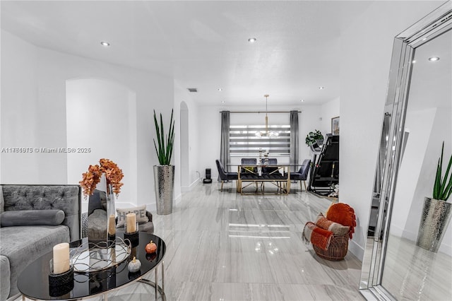 living room with visible vents, recessed lighting, baseboards, and arched walkways