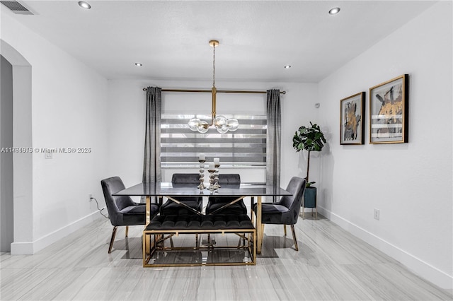 dining space featuring visible vents, baseboards, recessed lighting, an inviting chandelier, and arched walkways