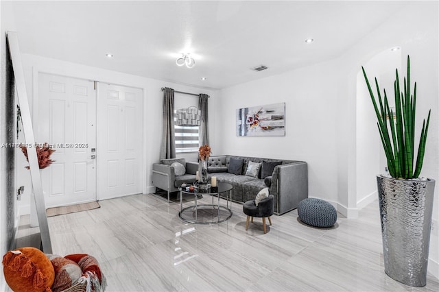 living room with visible vents and baseboards