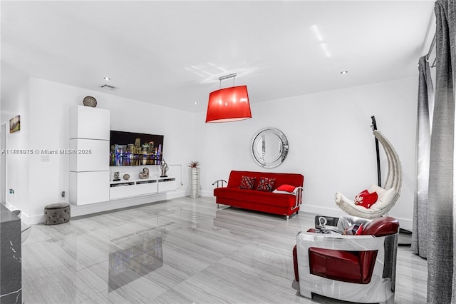 living area with visible vents and baseboards