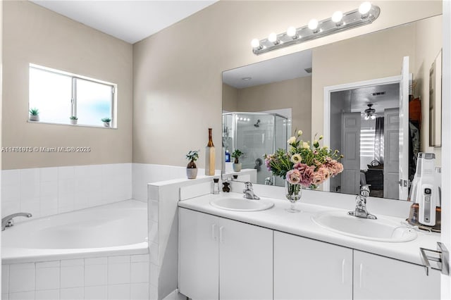 full bath featuring double vanity, a bath, a stall shower, and a sink