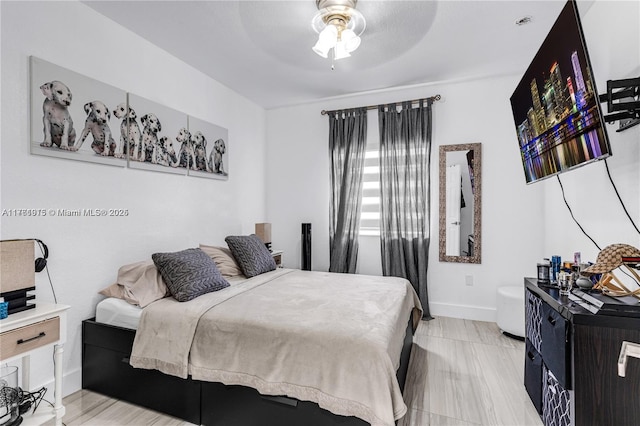 bedroom with baseboards and ceiling fan