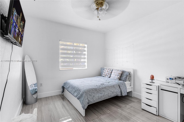 bedroom featuring a ceiling fan and baseboards