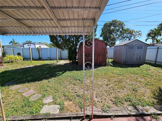 view of yard featuring a storage shed, a fenced backyard, and an outdoor structure