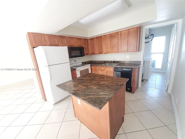 kitchen with a center island, black appliances, light tile patterned floors, and a sink