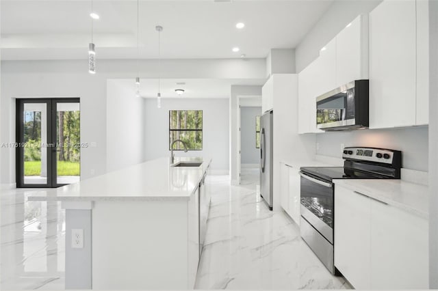 kitchen featuring white cabinets, modern cabinets, marble finish floor, and stainless steel appliances