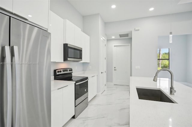 kitchen with visible vents, appliances with stainless steel finishes, marble finish floor, modern cabinets, and a sink