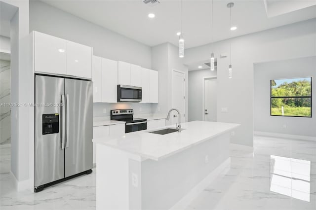 kitchen with marble finish floor, appliances with stainless steel finishes, white cabinetry, and light countertops