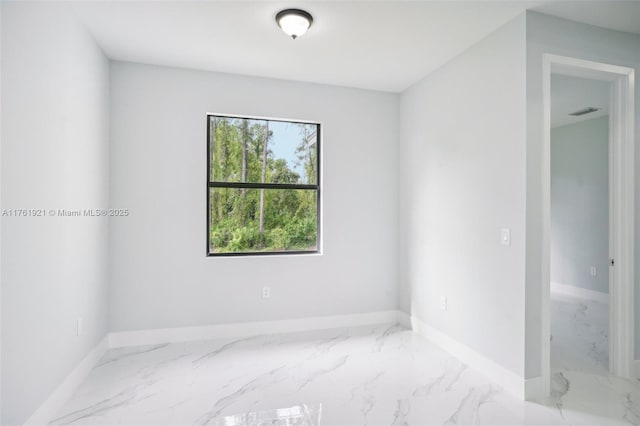 spare room featuring visible vents, marble finish floor, and baseboards