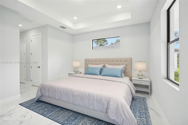 bedroom with visible vents, marble finish floor, a raised ceiling, and multiple windows