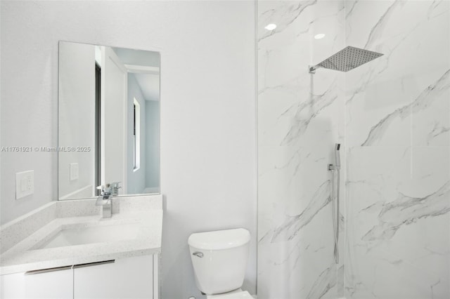 bathroom with vanity, toilet, and a marble finish shower