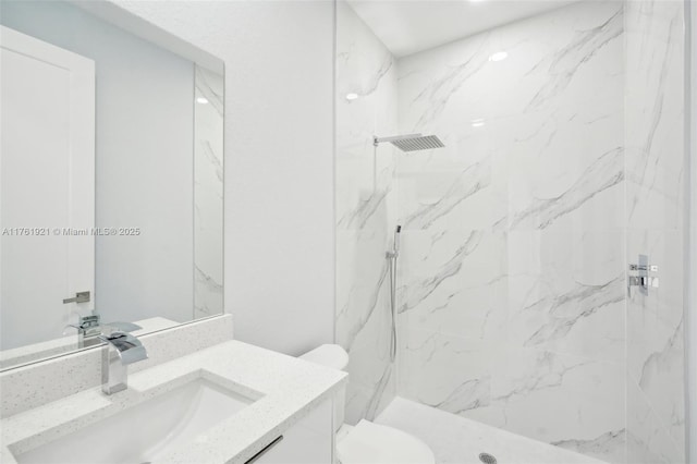 full bathroom featuring a marble finish shower, toilet, and vanity