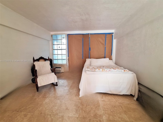 bedroom featuring a wall mounted air conditioner