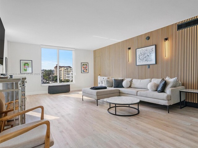10350 W Bay Harbor Dr Unit 4H, Bay Harbor Islands, FL 33154 - living room featuring wood finished floors, wood walls, and baseboards