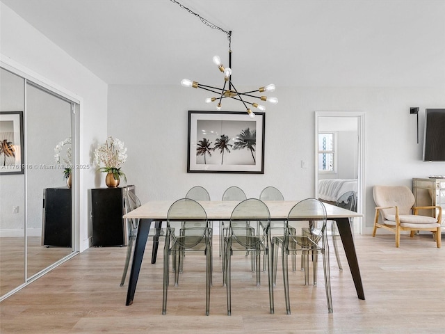 10350 W Bay Harbor Dr Unit 4H, Bay Harbor Islands, FL 33154 - dining space with light wood-type flooring, baseboards, and an inviting chandelier