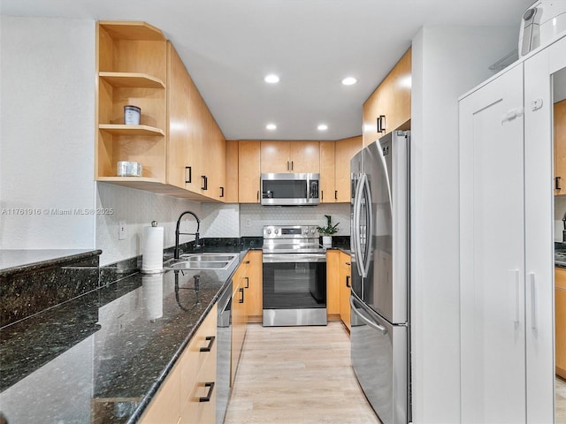 10350 W Bay Harbor Dr Unit 4H, Bay Harbor Islands, FL 33154 - kitchen with light brown cabinetry, stainless steel appliances, a sink, light wood-style floors, and dark stone counters