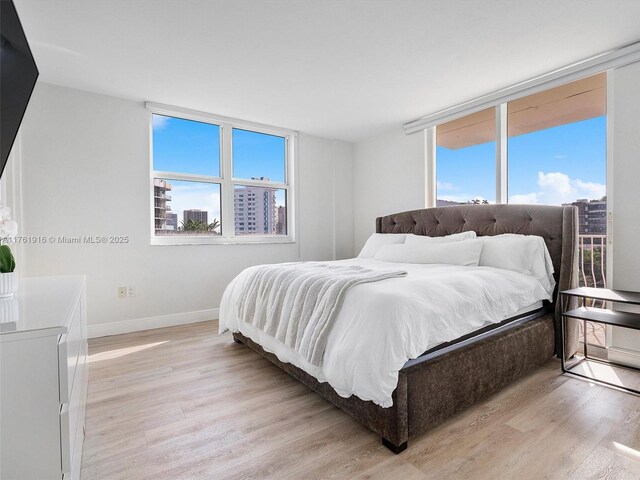 10350 W Bay Harbor Dr Unit 4H, Bay Harbor Islands, FL 33154 - bedroom featuring baseboards, multiple windows, and light wood-style floors