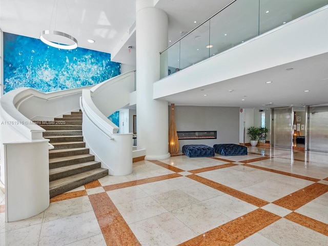 10350 W Bay Harbor Dr Unit 4H, Bay Harbor Islands, FL 33154 - interior space with recessed lighting, a high ceiling, elevator, a glass covered fireplace, and stairs