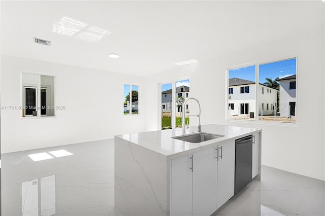 kitchen with visible vents, marble finish floor, a center island with sink, a sink, and dishwashing machine