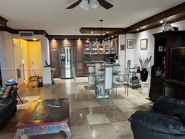 living room featuring visible vents and a ceiling fan