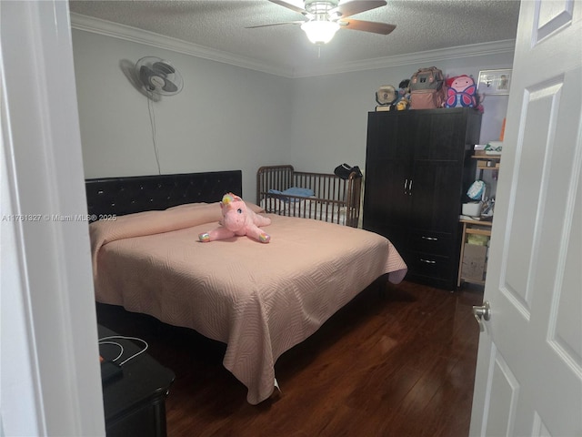 bedroom with dark wood-type flooring, ornamental molding, and a textured ceiling