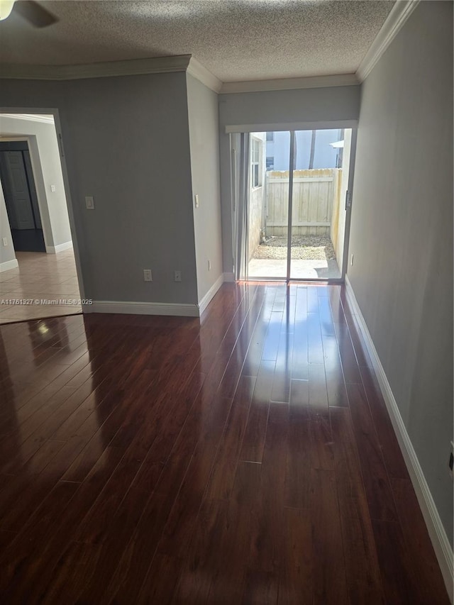 7655 SW 153rd Ct Unit 102, Miami, FL 33193 - spare room with dark wood finished floors, a ceiling fan, baseboards, a textured ceiling, and ornamental molding