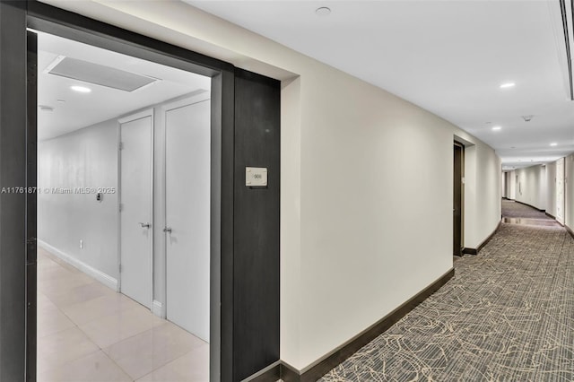 hallway featuring recessed lighting and baseboards