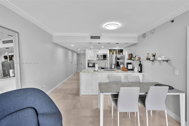 dining area with light tile patterned floors, baseboards, visible vents, and ornamental molding