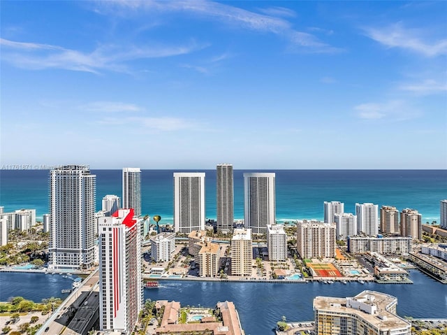 birds eye view of property featuring a view of city and a water view