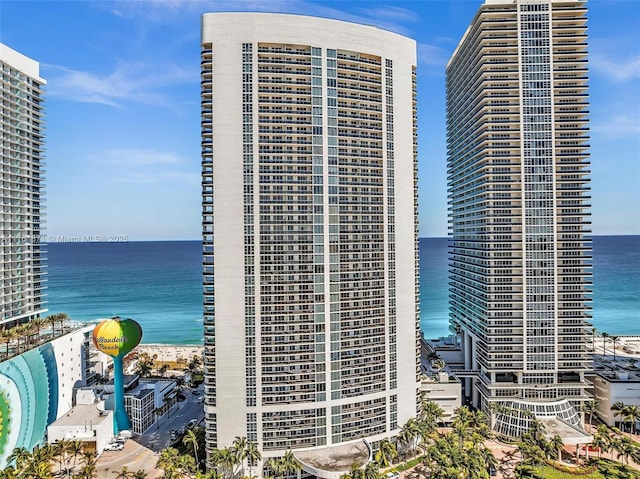 view of building exterior with a city view and a water view