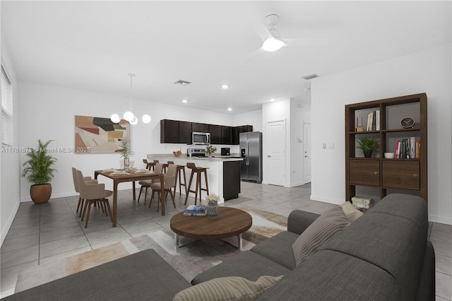 living room with light tile patterned flooring, recessed lighting, and visible vents