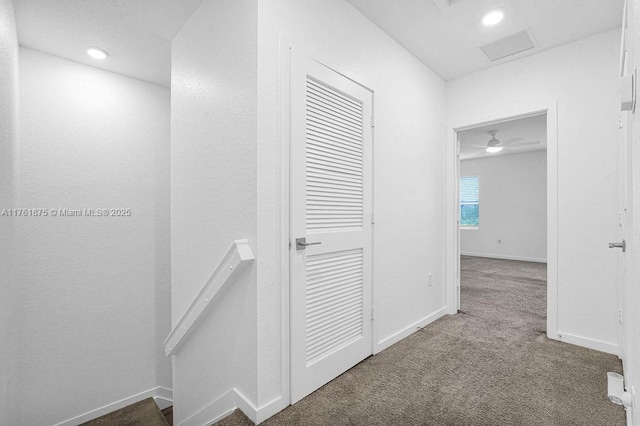 hall with visible vents, baseboards, an upstairs landing, carpet flooring, and recessed lighting