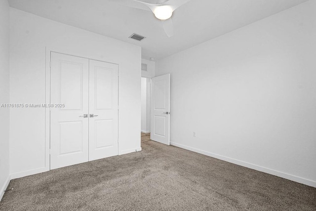 unfurnished bedroom with visible vents, a closet, carpet, baseboards, and ceiling fan