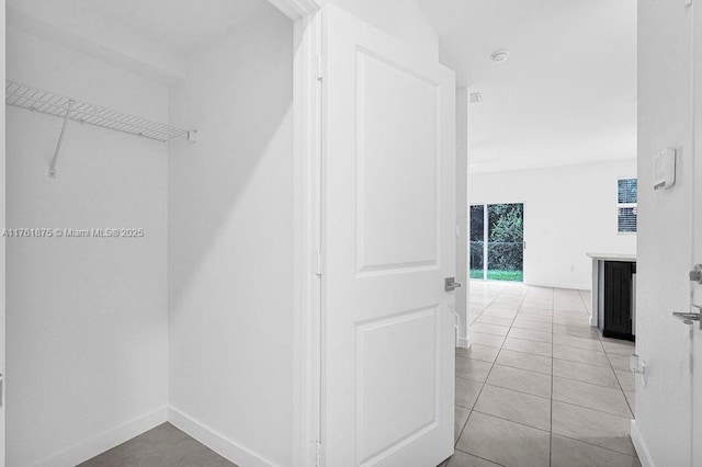 interior space with light tile patterned floors and baseboards