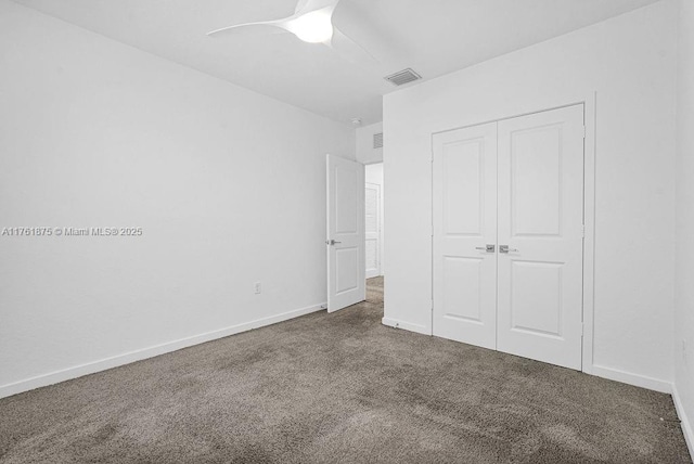 unfurnished bedroom with visible vents, baseboards, carpet flooring, a closet, and a ceiling fan