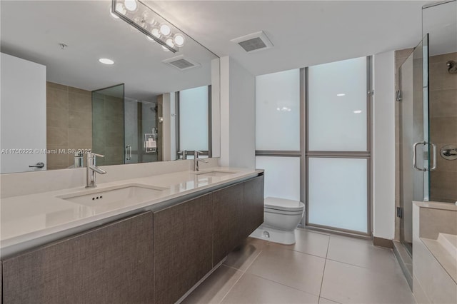 bathroom with a sink, a stall shower, and tile patterned floors