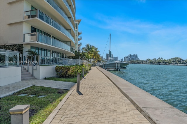 view of community featuring a water view and a boat dock