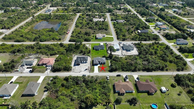 drone / aerial view featuring a residential view and a water view