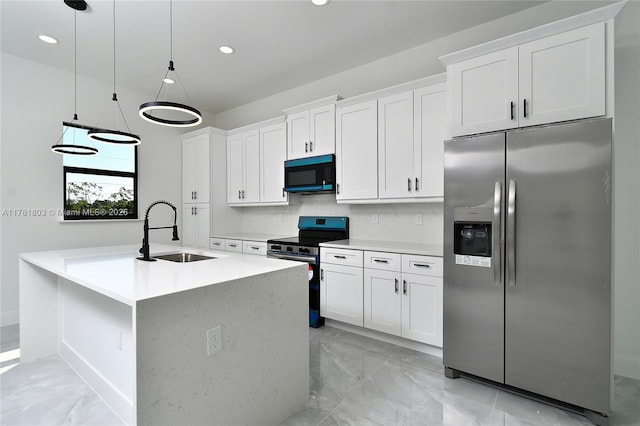 kitchen with a sink, stainless steel appliances, marble finish floor, and white cabinets