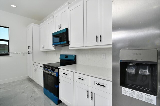 kitchen featuring baseboards, stainless steel appliances, light countertops, white cabinets, and marble finish floor